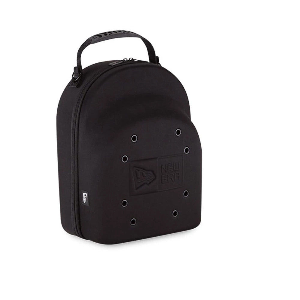 New Era 6 Pack Black Cap Carrier, three-quarter view showing the arched black case with a debossed New Era logo centred on the front, a row of eyelets surrounding the logo, and a short carry handle attached at the top.