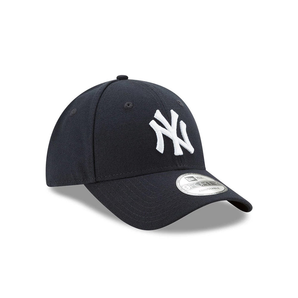 New York Yankees The League Blue New Era 9FORTY Cap, three-quarter view showing white embroidered NY logo on the front panel, curved blue visor with a silver 9FORTY size sticker, and black eyelets on the structured crown.