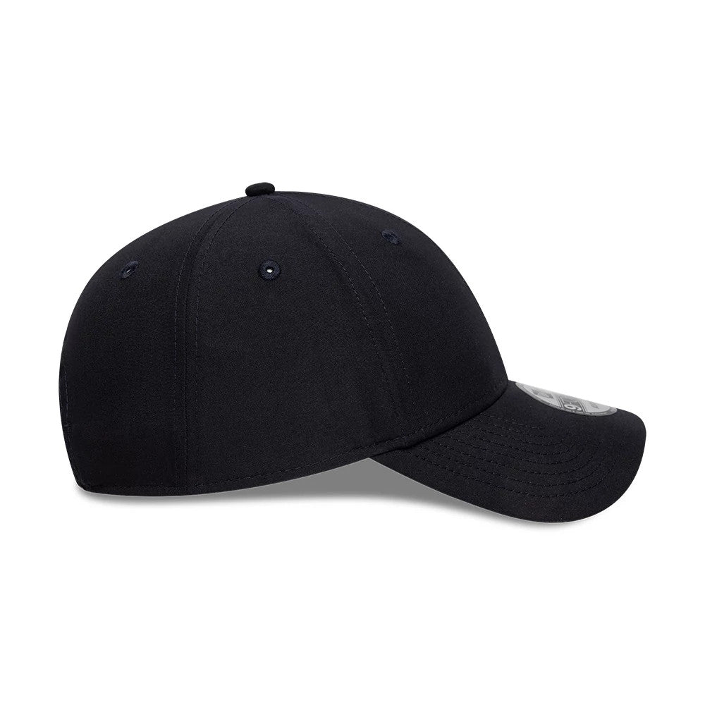 New York Yankees Flawless Navy New Era 9FORTY Cap, side view showing the curved visor with a 9FORTY size sticker, navy crown with tonal eyelets, and a streamlined fit beneath the top button.
