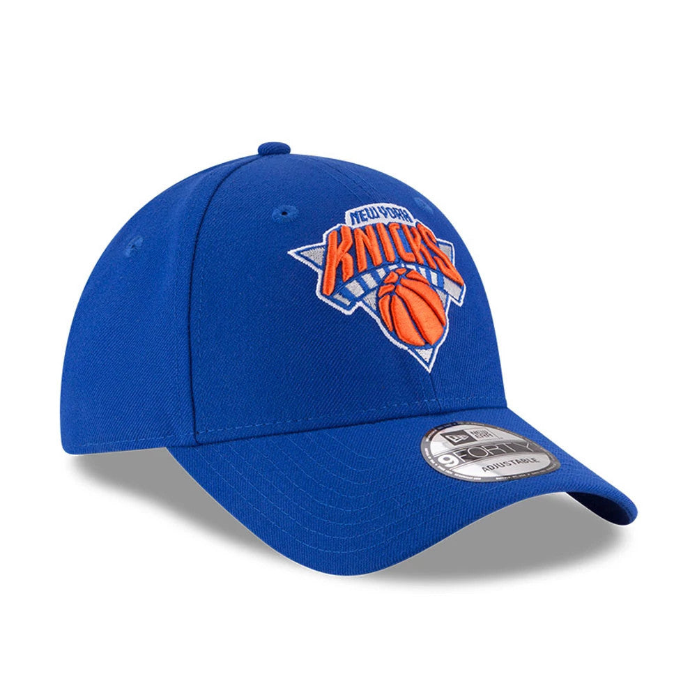 New York Knicks The League Blue New Era 9FORTY Cap, three-quarter view showing the raised orange and blue team logo embroidered on the front panel, a curved visor, and the 9FORTY size sticker on top.