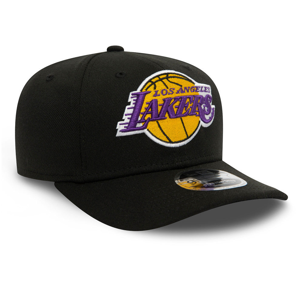 LA Lakers Black New Era 9FIFTY Stretch Snap Cap, three-quarter view showing the raised embroidered Lakers logo in purple and yellow on the front panel, with a 9FIFTY size sticker on the black visor.