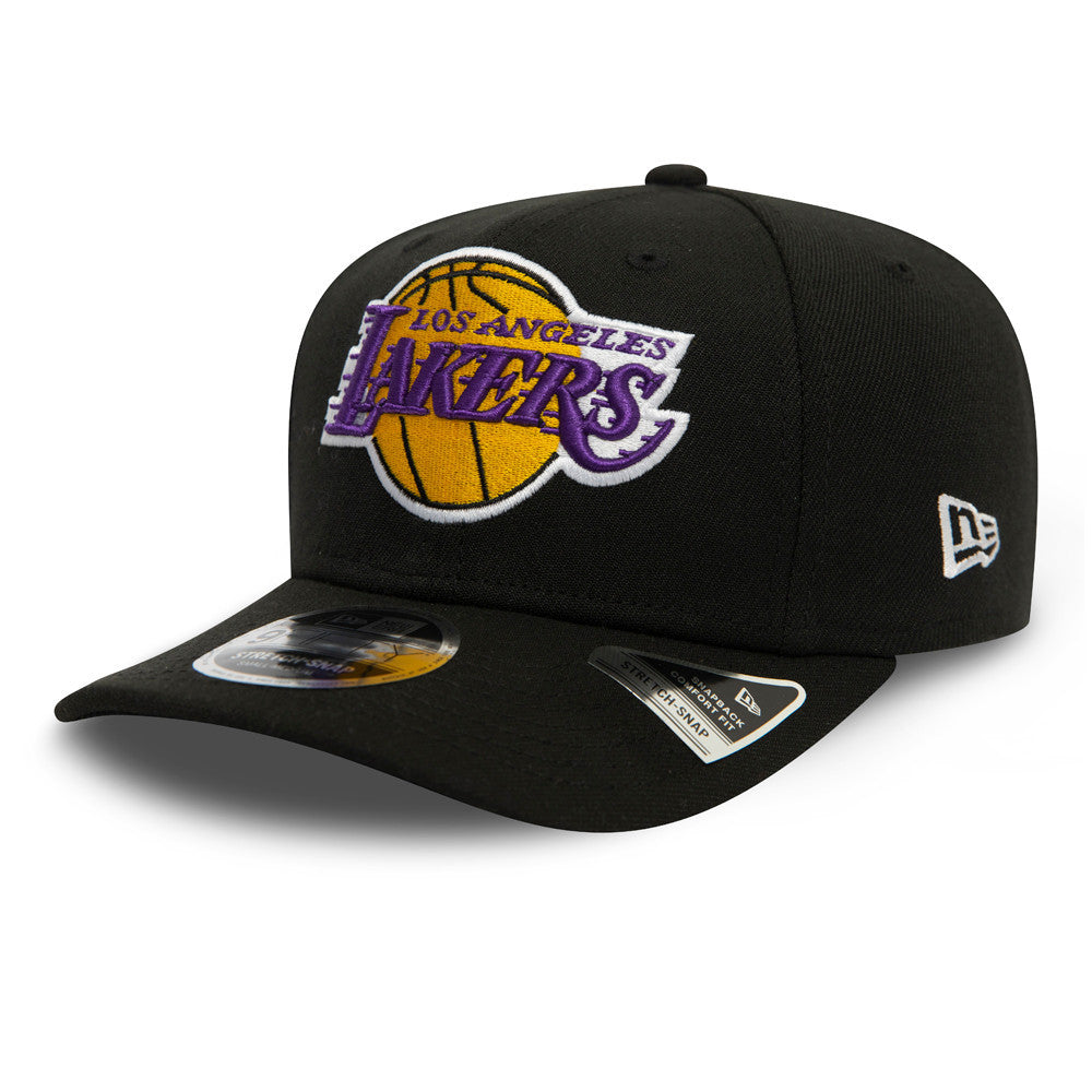 LA Lakers Black New Era 9FIFTY Stretch Snap Cap, three-quarter view showing the purple and gold embroidered Lakers logo on the front panel, with New Era flag logo on the left side and a 9FIFTY size sticker on the black visor.