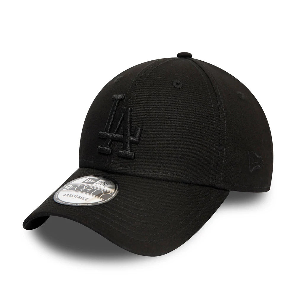 LA Dodgers Essential Black on Black New Era 9FORTY Cap, three-quarter view showing raised black LA logo embroidered on the front panel, curved visor with a 9FORTY size sticker, and the New Era flag logo on the left side.