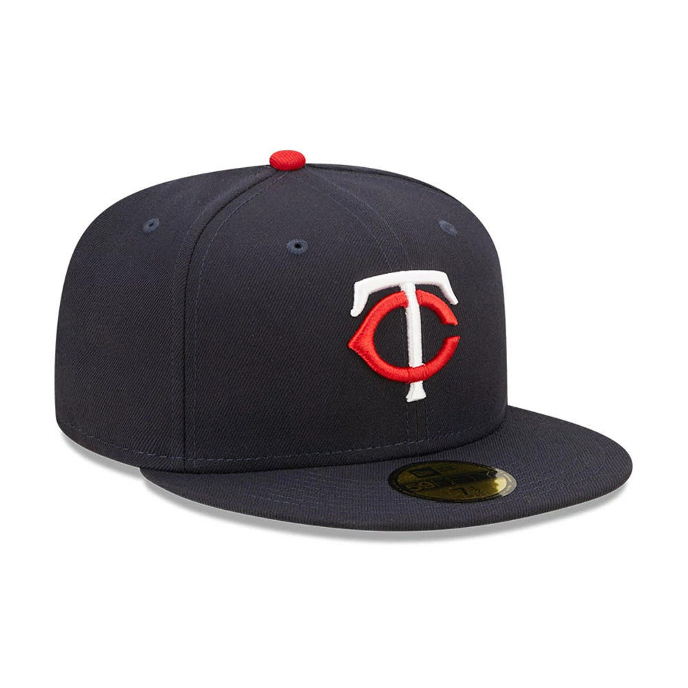 Minnesota Twins Authentic On Field Navy New Era 59FIFTY Cap, front view showing a raised TC logo in white and red embroidery on the navy crown, with a gold 59FIFTY size sticker on the flat visor and a red top button.