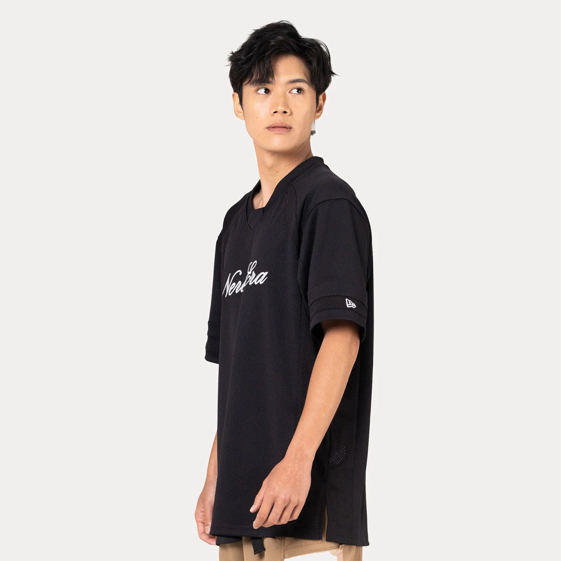 The Male model is wearing New Era Heritage Black Football Jersey 2