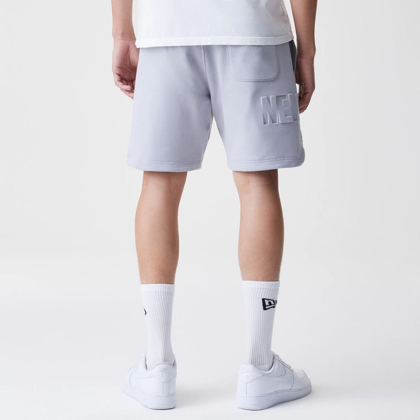The Male model is wearing New Era Tonal Pack Grey Shorts 8