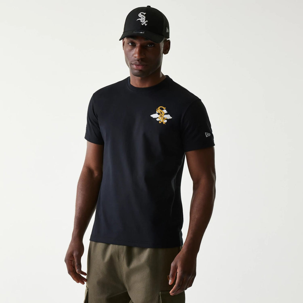 Chicago White Sox MLB 59FIFTY Pack Cloud Black T-Shirt, on-model view showing a black t-shirt with a white and gold winged logo on the chest, paired with a black cap featuring a raised white team emblem on the front.