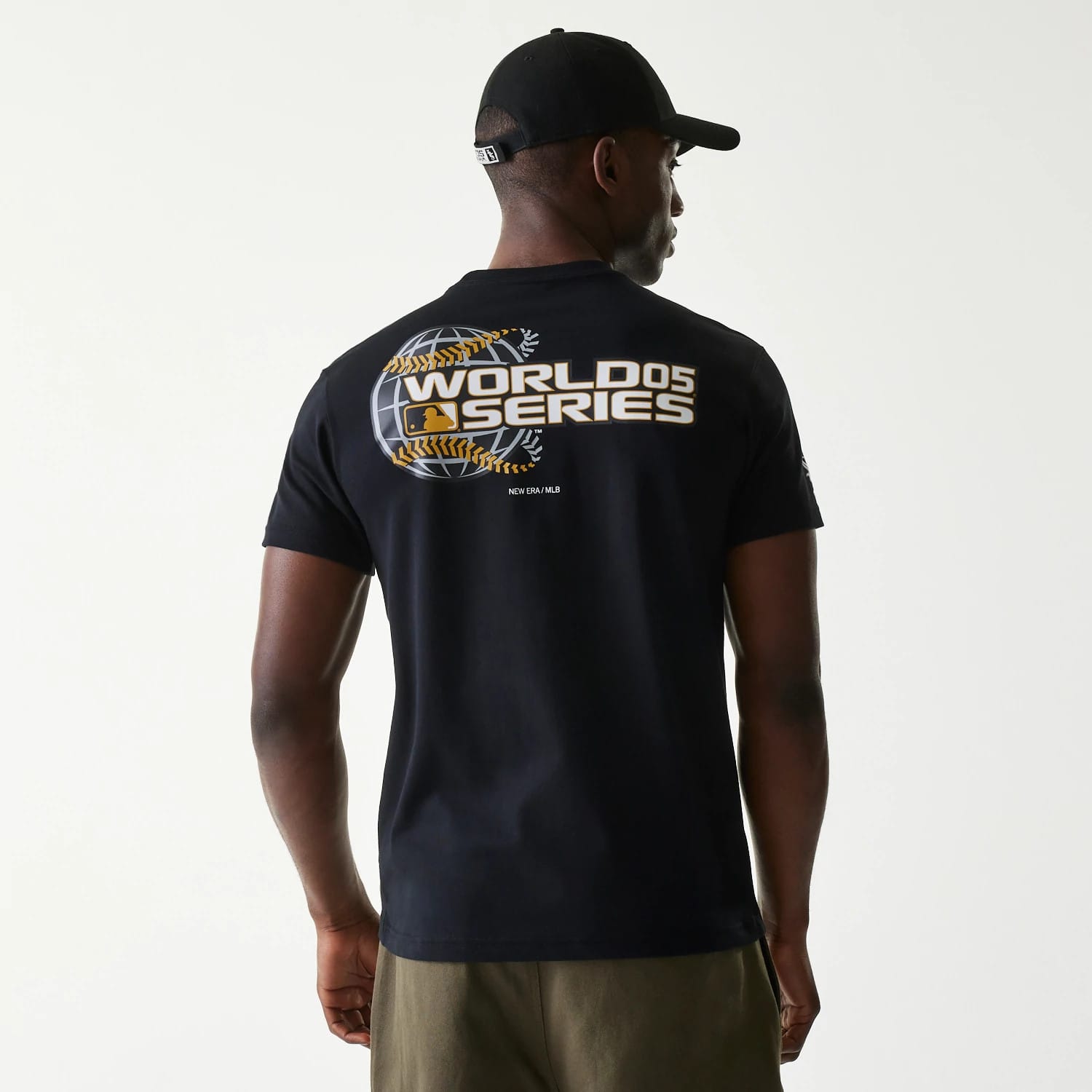 Chicago White Sox MLB 59FIFTY Pack Cloud Black T-Shirt, rear view displaying a bold World Series graphic with a globe design and white lettering, worn by a person also wearing a black cap with a debossed logo on the back.