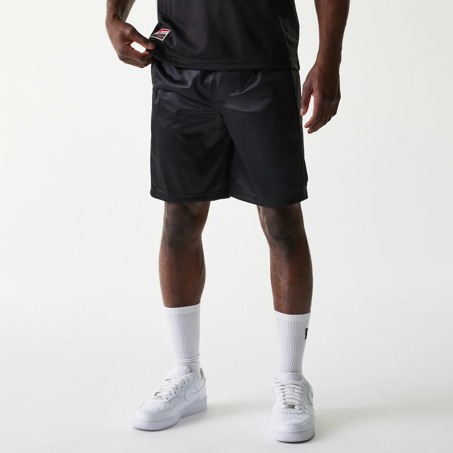 The Male model is wearing New Era Retro Sports Black Mesh Shorts 1