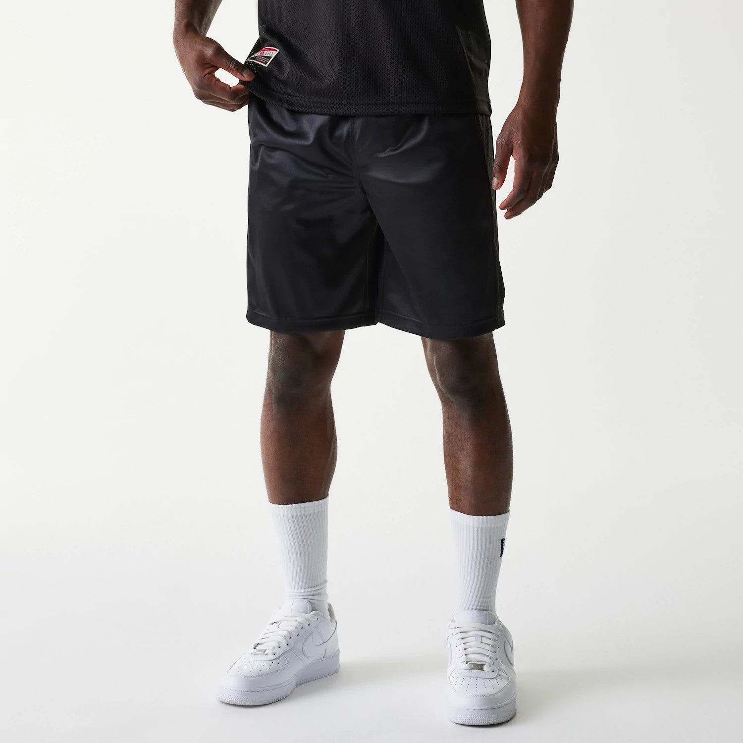 The Male model is wearing New Era Retro Sports Black Mesh Shorts 1