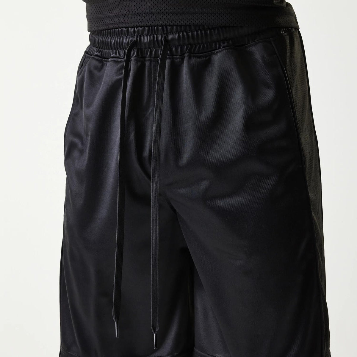 The Male model is wearing New Era Retro Sports Black Mesh Shorts 3