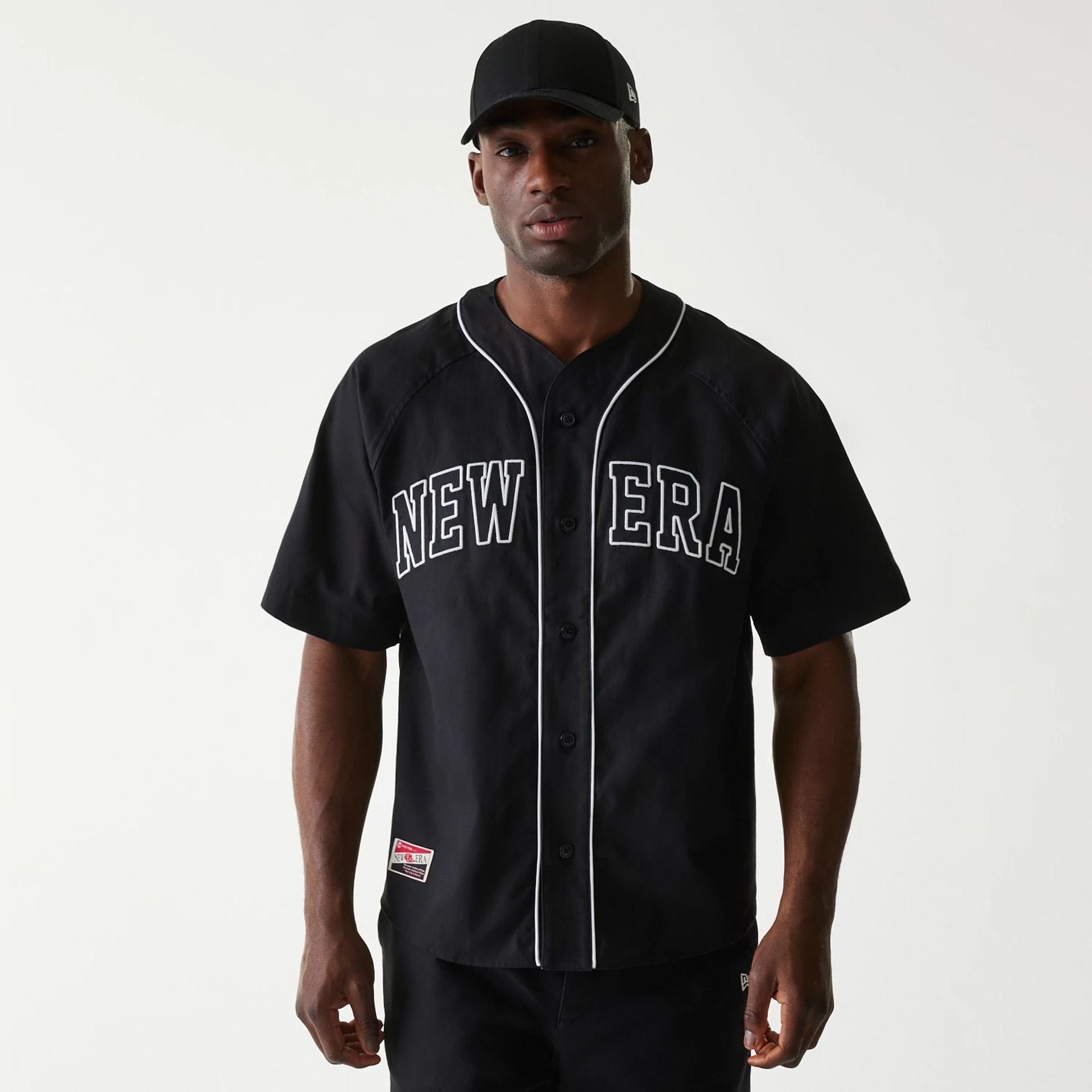 The Male model is wearing New Era Retro Baseball Black Short Sleeve Shirt 1