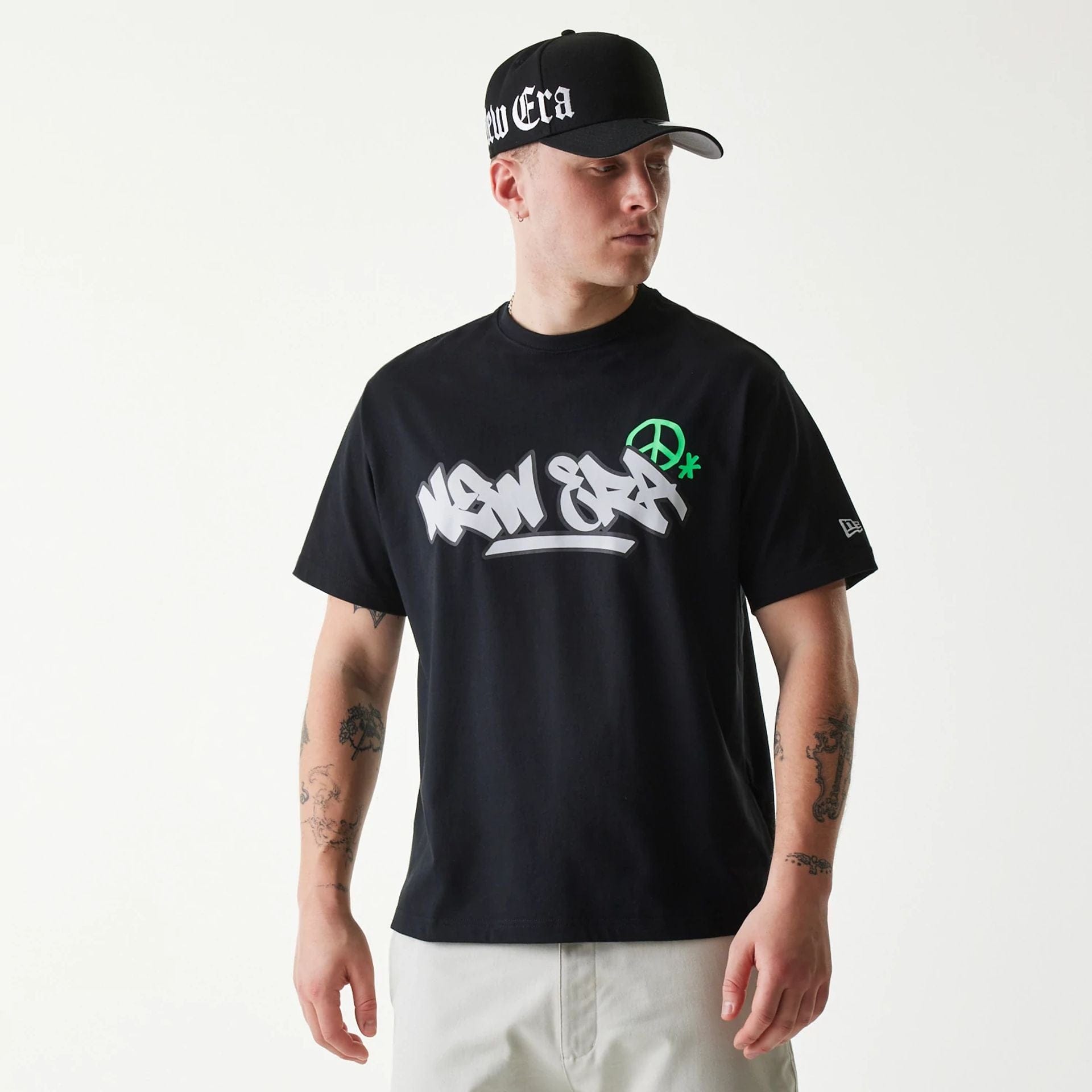 The Male model is wearing New Era Peace Symbol Black T-Shirt 1