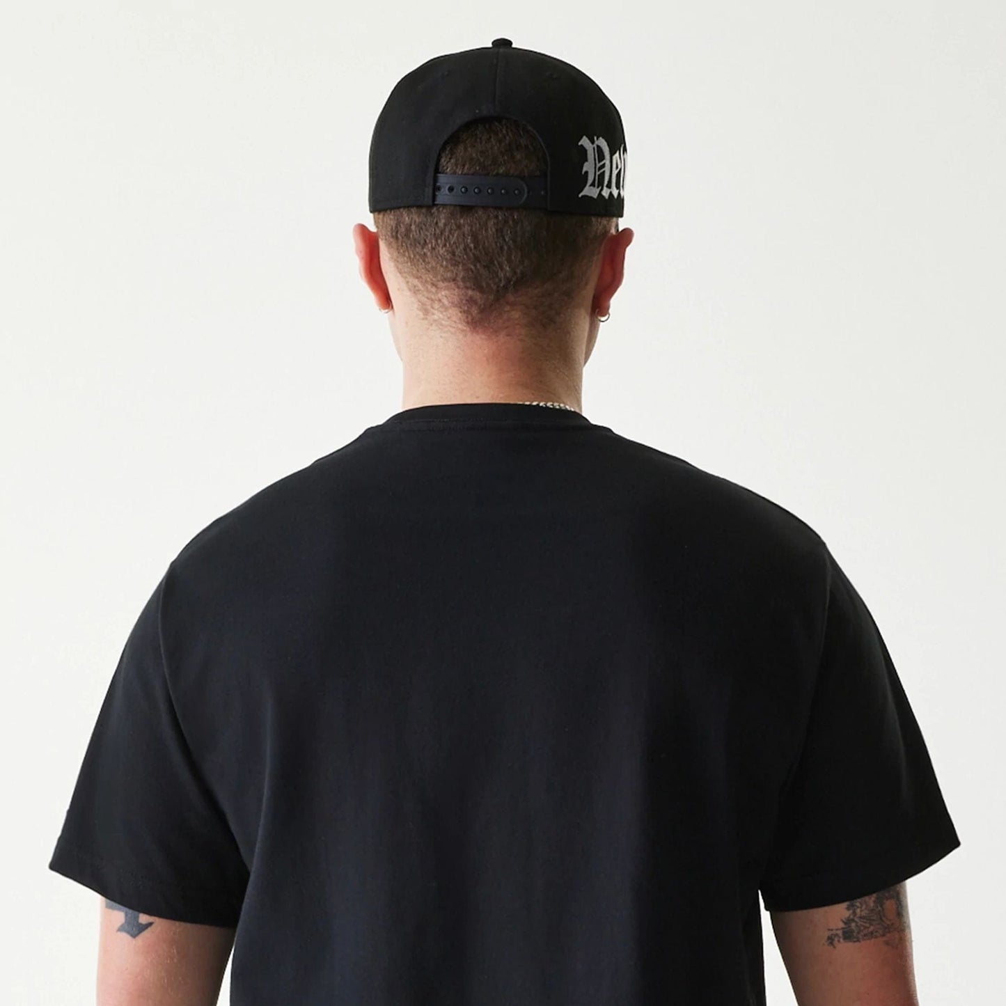 The Male model is wearing New Era Peace Symbol Black T-Shirt 7