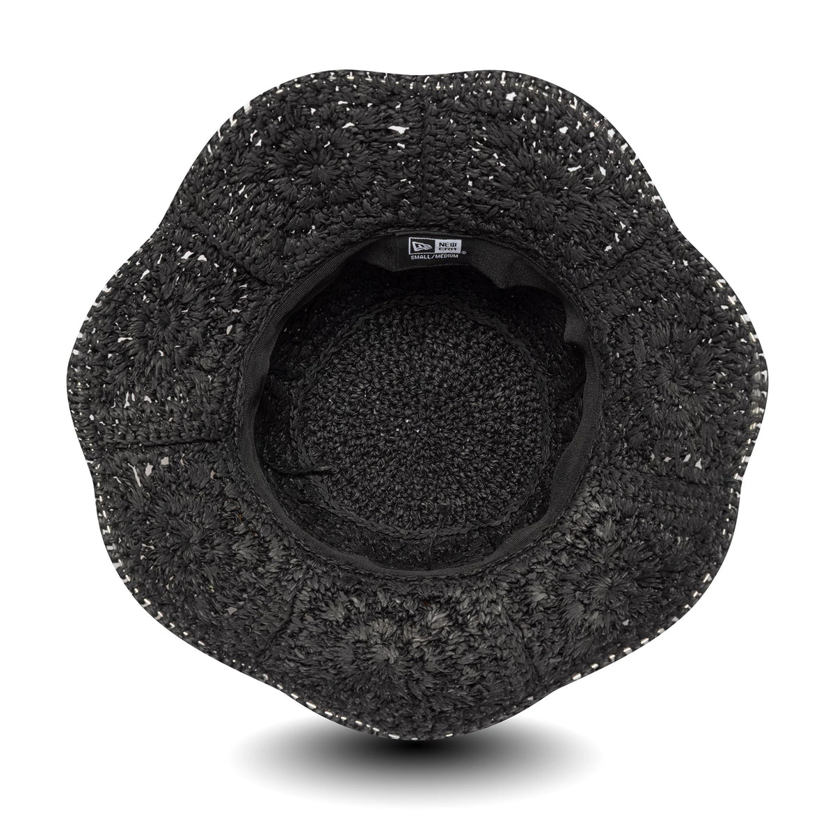 New Era Paper Hat Black Adventure Bucket Hat, inside view showing the intricate woven texture and black sweatband with a New Era label, the wide brim providing a distinct scalloped edge.