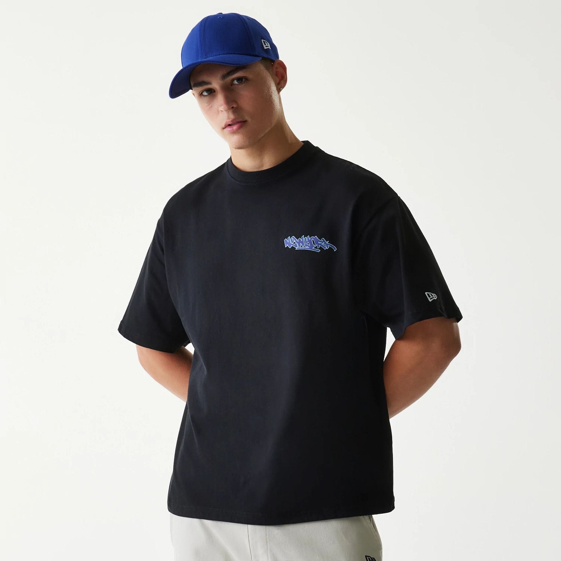 The Male model is wearing New Era Japan Tagging Logo Black T-Shirt 1