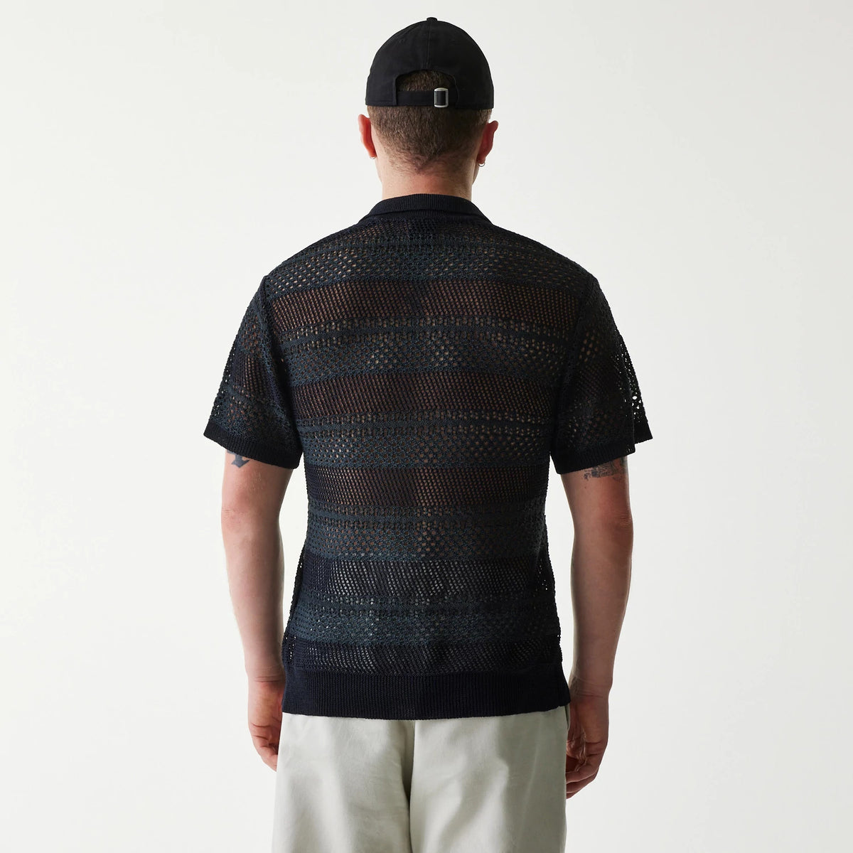 The Male model is wearing New Era Japan Mesh Black Polo T-Shirt 2