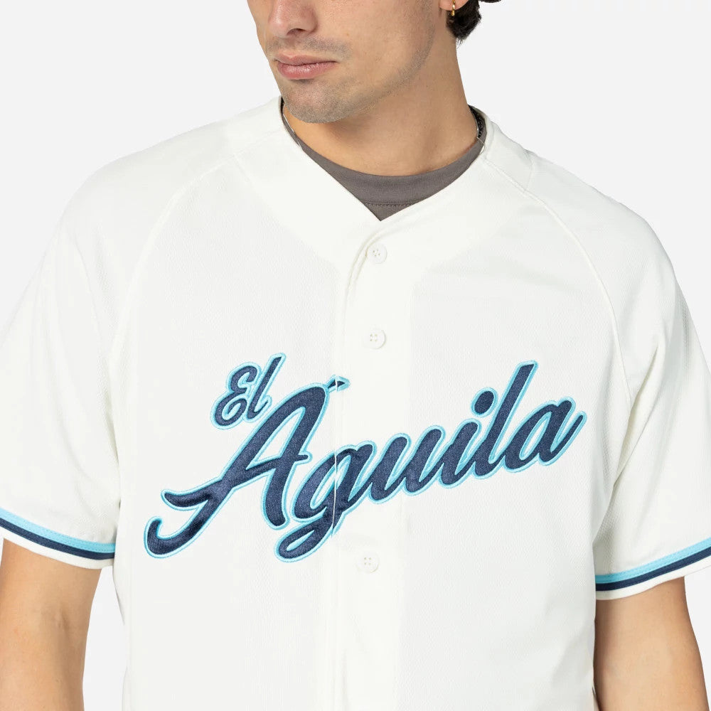Veracruz Aguilas Mexico LMB On Field Cream On-Field Jersey, front view on a model showing the El Aguila script logo in blue embroidery across the chest and matching striped detailing on the sleeves.
