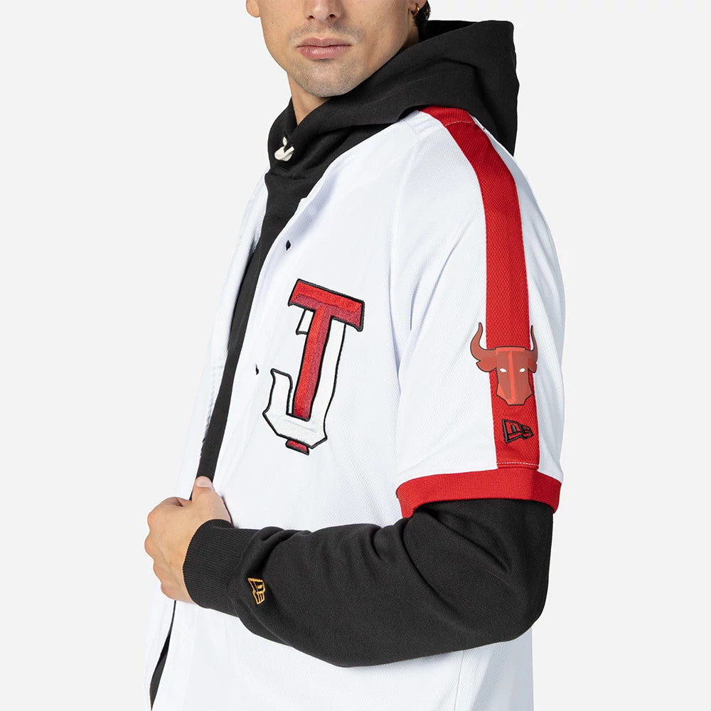 Tijuana Toros Mexico LMB On Field White On-Field Jersey, side view on a model wearing a black hoodie underneath, with a red bull logo on the sleeve and a prominent red J logo on the front.