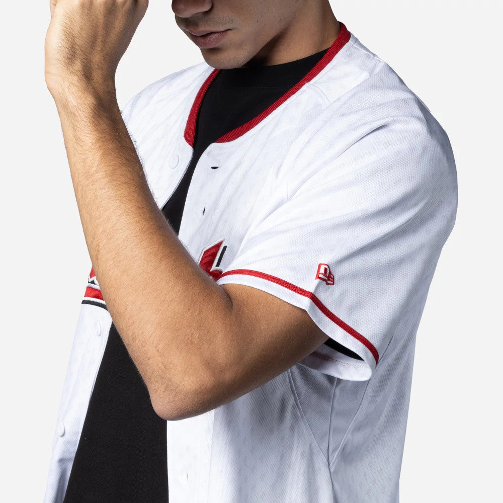 Mexico Diablos Mexico LMB On Field White On-Field Jersey, side view on a model with an arm raised showing the New Era flag logo embroidered on the right sleeve and red accent stripes on the collar and sleeves.