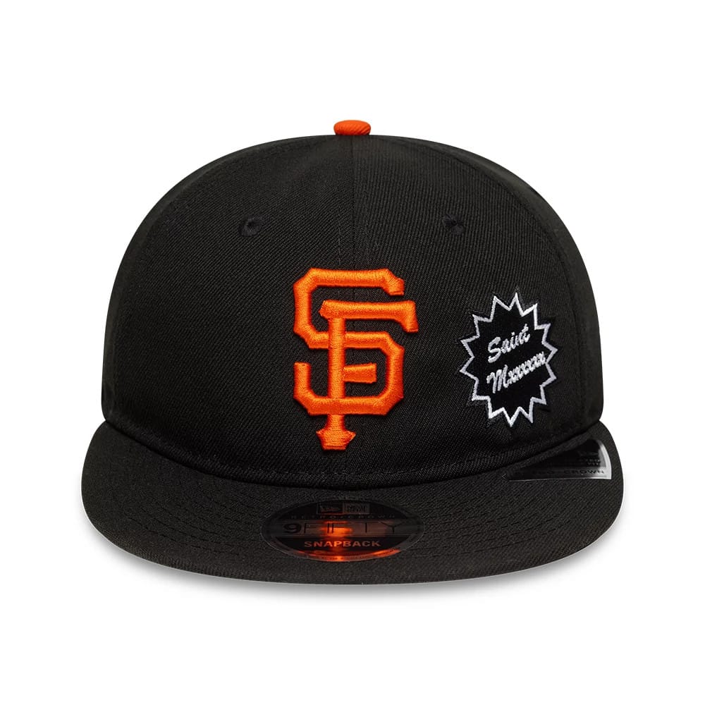 San Francisco Giants MLB X Saint Mxxxxxx Black Retro Crown New Era 9FIFTY Snapback Adjustable Cap, front view with orange SF logo and Saint Mxxxxxx patch on the front panel, black visor and 9FIFTY size sticker.