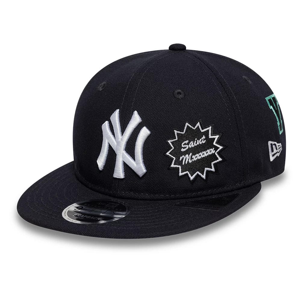 New York Yankees MLB X Saint Mxxxxxx Navy Retro Crown New Era 9FIFTY Snapback Adjustable Cap, three-quarter view showing raised white NY logo on the front panel, embroidered Saint Mxxxxxx patch on the side, and 9FIFTY size sticker on the visor.