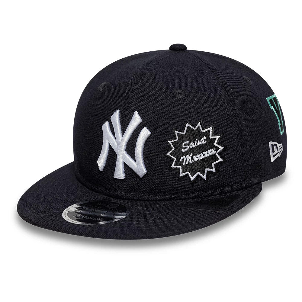 New York Yankees MLB X Saint Mxxxxxx Navy Retro Crown New Era 9FIFTY Snapback Adjustable Cap, three-quarter view showing raised white NY logo on the front panel, embroidered Saint Mxxxxxx patch on the side, and 9FIFTY size sticker on the visor.