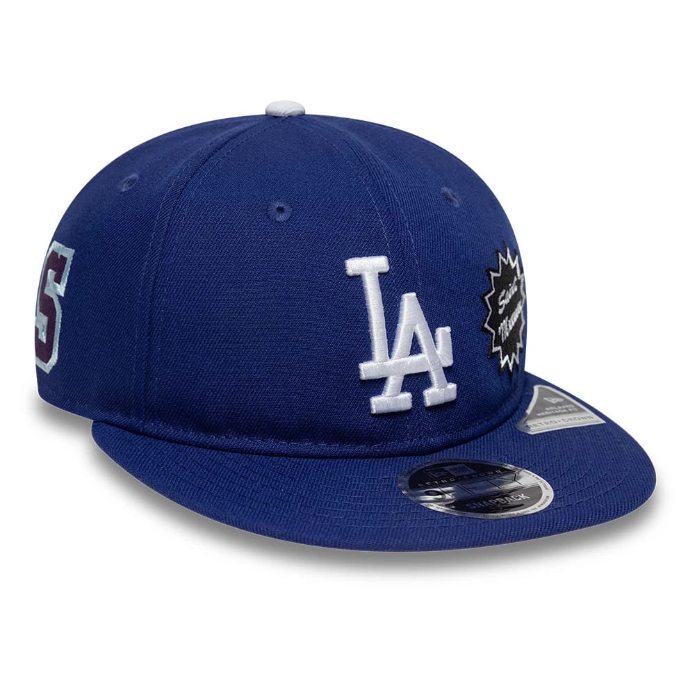 LA Dodgers MLB X Saint Mxxxxxx Dark Blue Retro Crown New Era 9FIFTY Snapback Adjustable Cap, three-quarter view showing the white embroidered LA logo on the front panel, black side patch, and 9FIFTY size sticker on the navy blue visor.