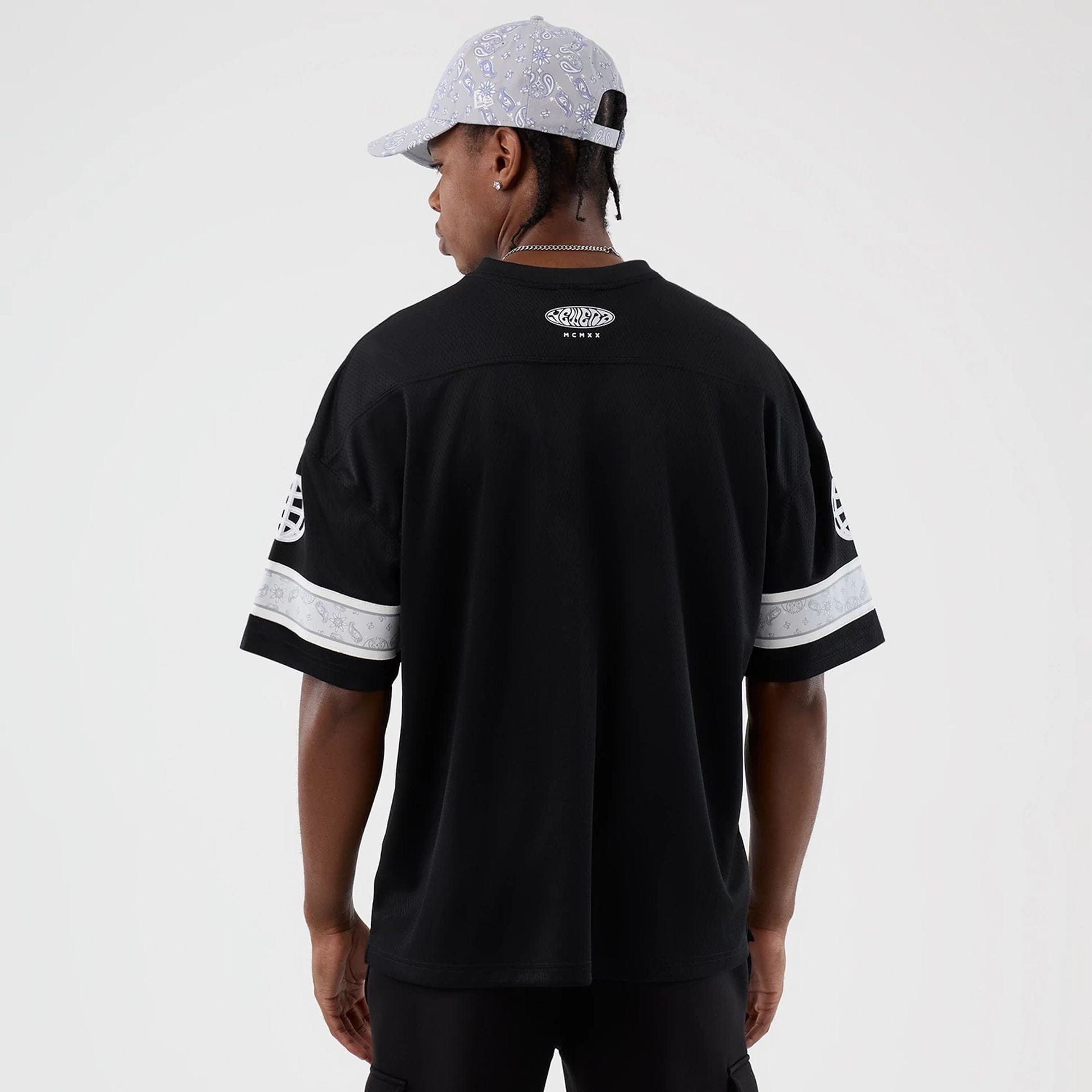 The Male model is wearing New Era Street Swing Black T-Shirt 2