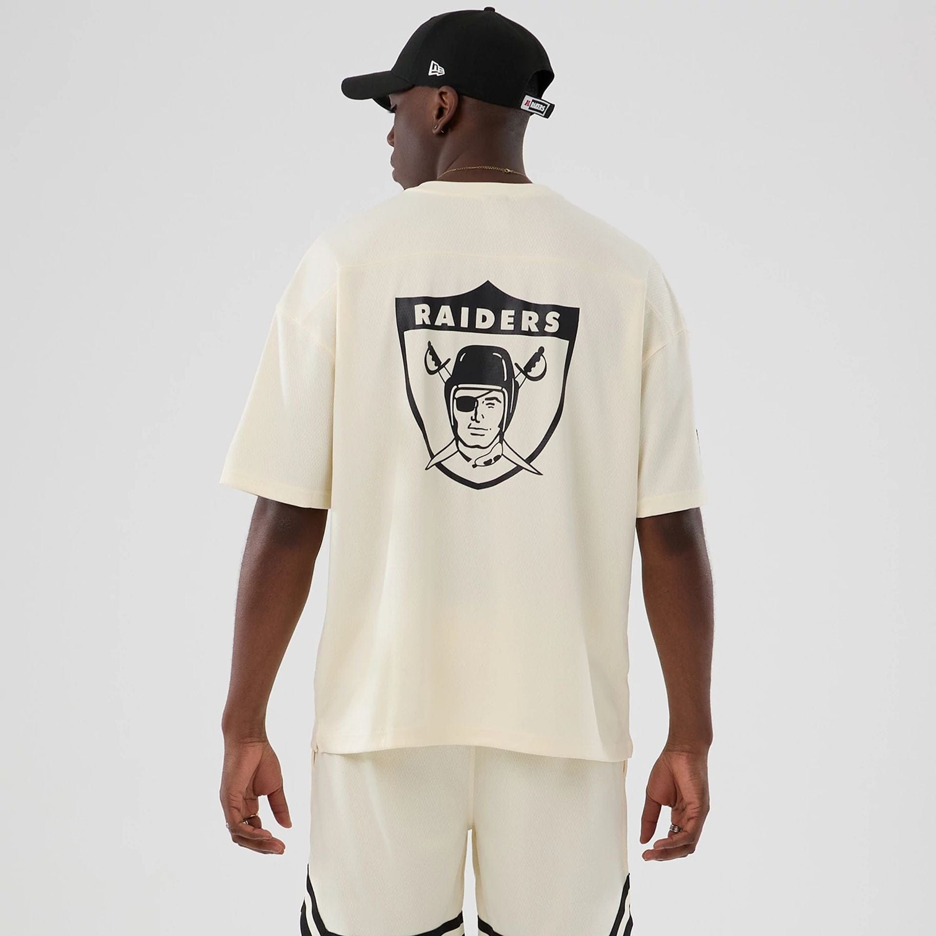 The model is wearing this NFL Historic Las Vegas Raiders Oversized T-Shirt in cream. 2