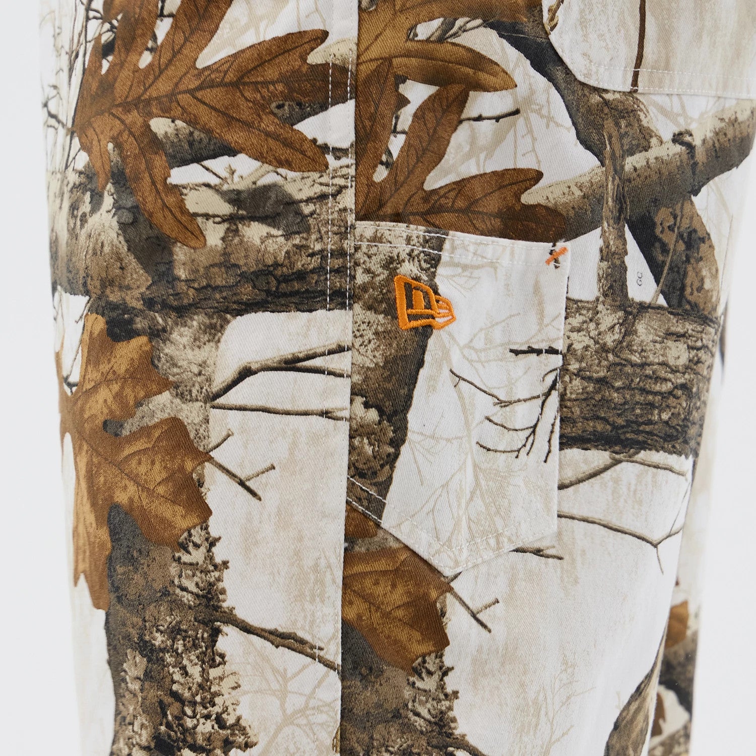 The Male model is wearing New Era Earthy Skin Real Tree Snow Oversized Shorts 4