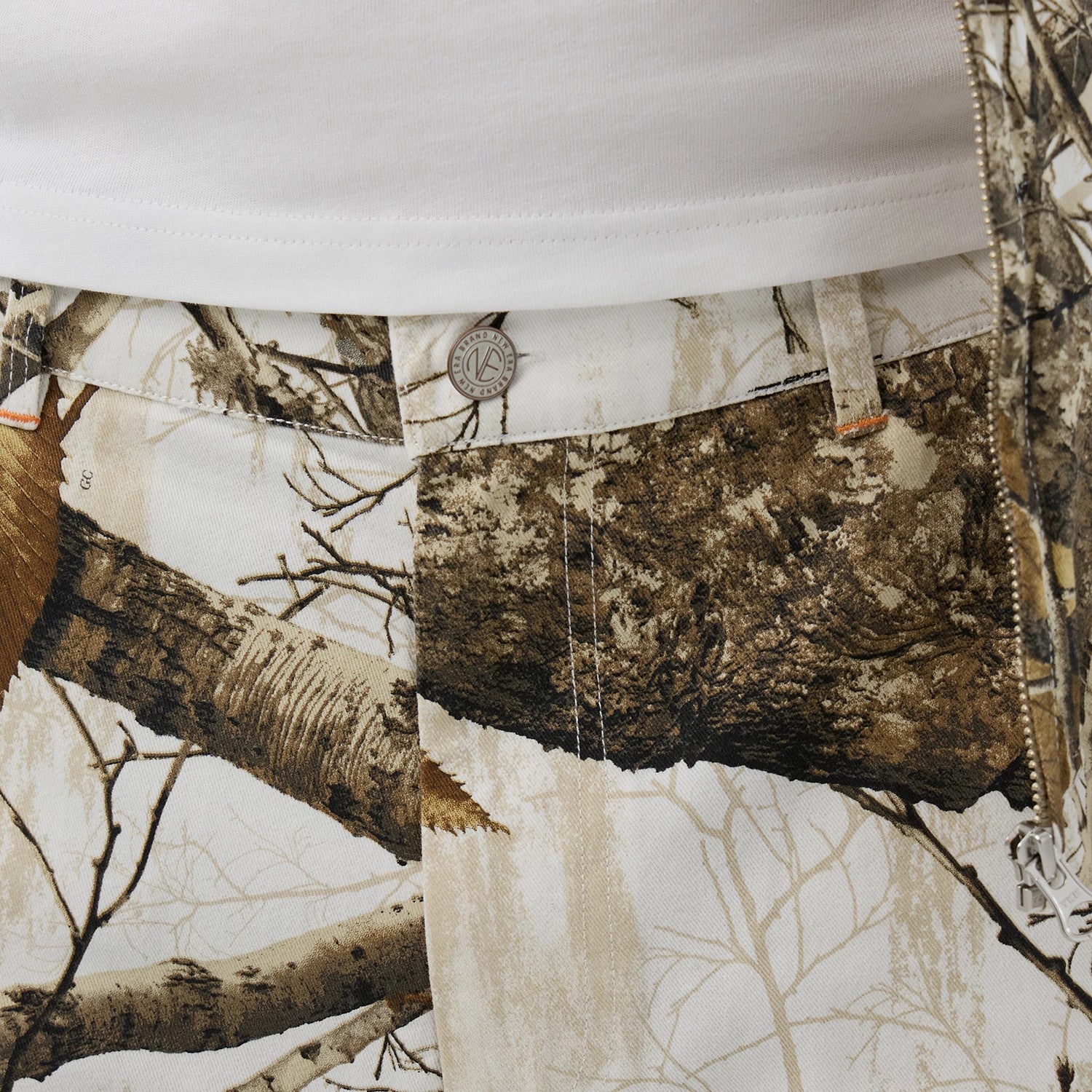 The Male model is wearing New Era Earthy Skin Real Tree Snow Oversized Shorts 5