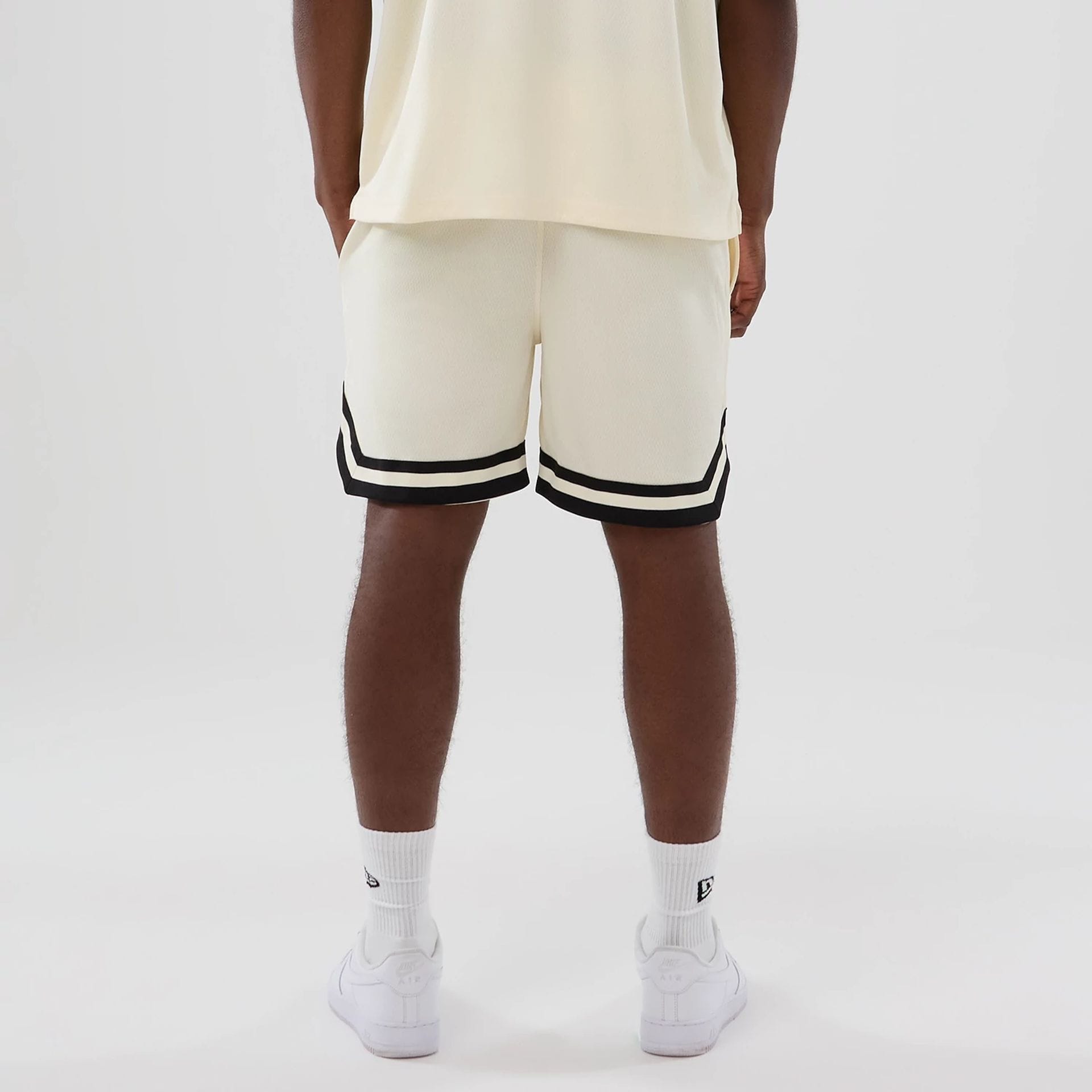 The model is wearing these NFL Historic Las Vegas Raiders shorts in cream. 2