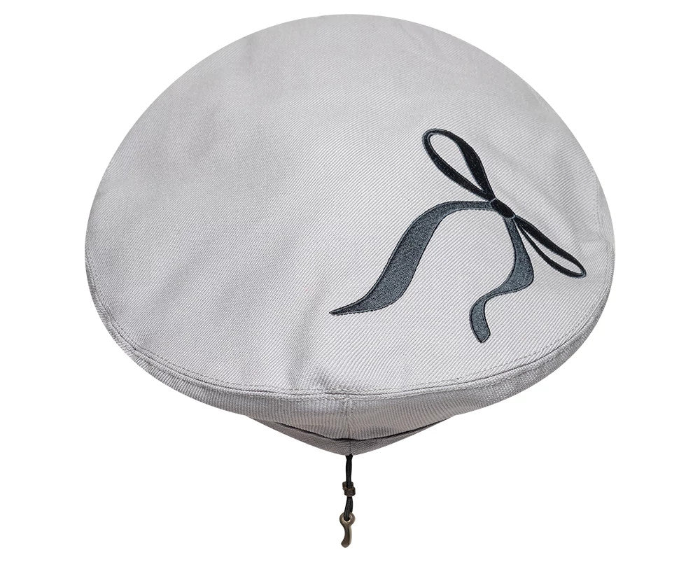 New Era Wool Grey Beret, top view showing a black embroidered ribbon design on the upper surface of the soft grey fabric, with a visible drawstring and hook hanging from the underside for adjustable wear.