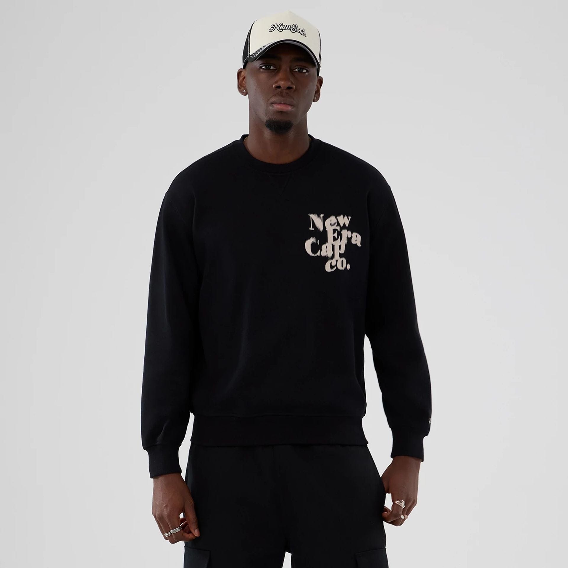 The Male model is wearing New Era Cap Company Black Crew Neck Sweater 1