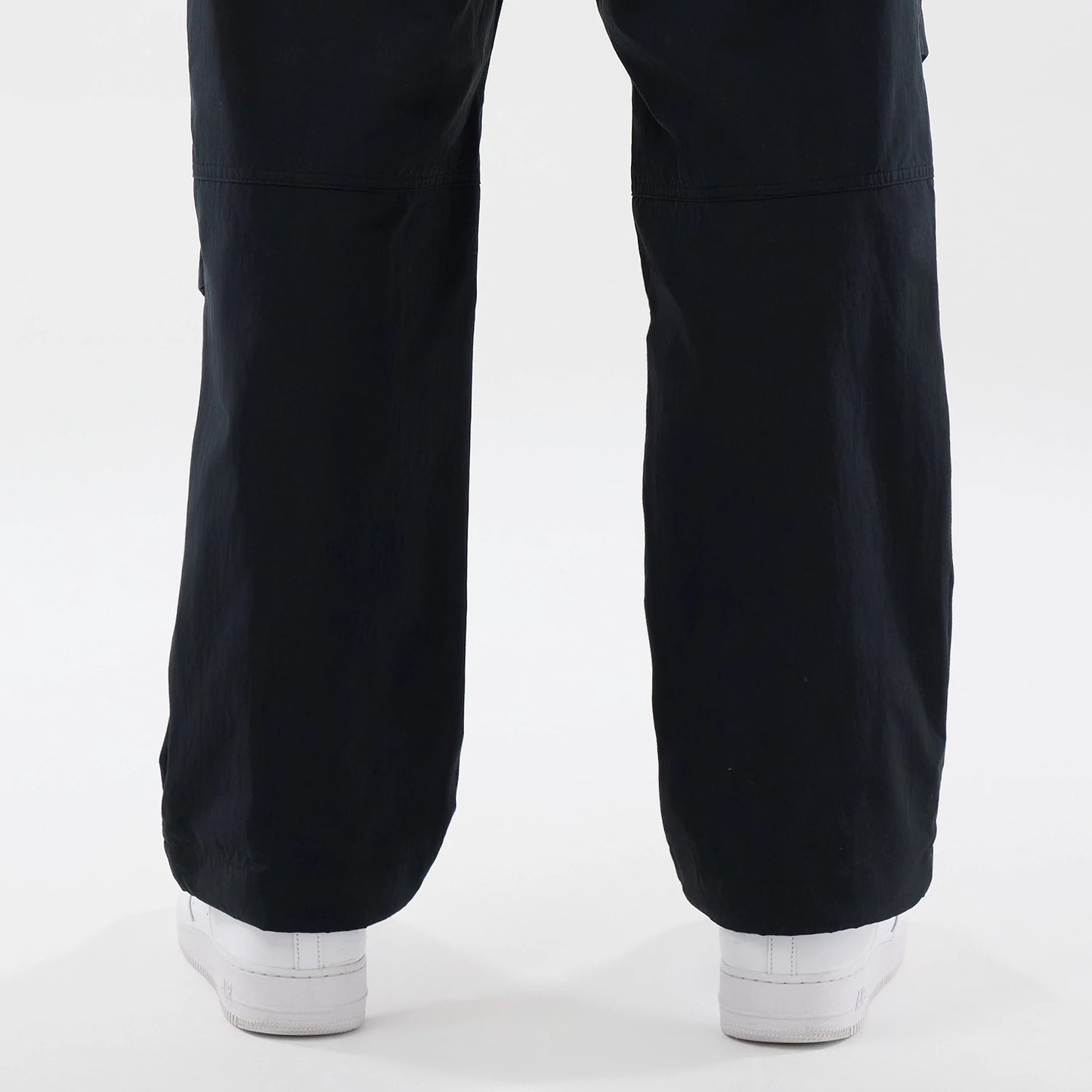 The Male model is wearing New Era Organic Black Parachute Trousers 7