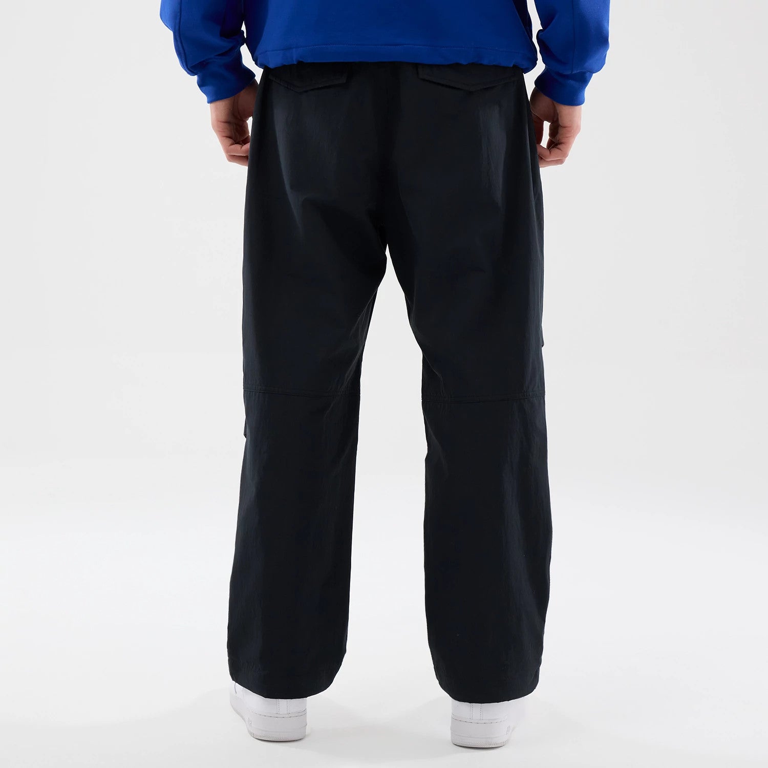 The Male model is wearing New Era Organic Black Parachute Trousers 2