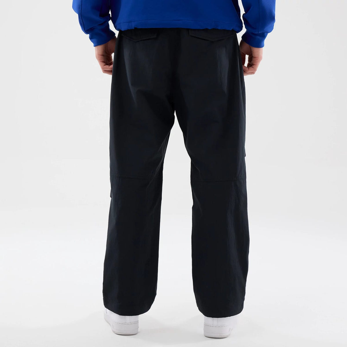 The Male model is wearing New Era Organic Black Parachute Trousers 2