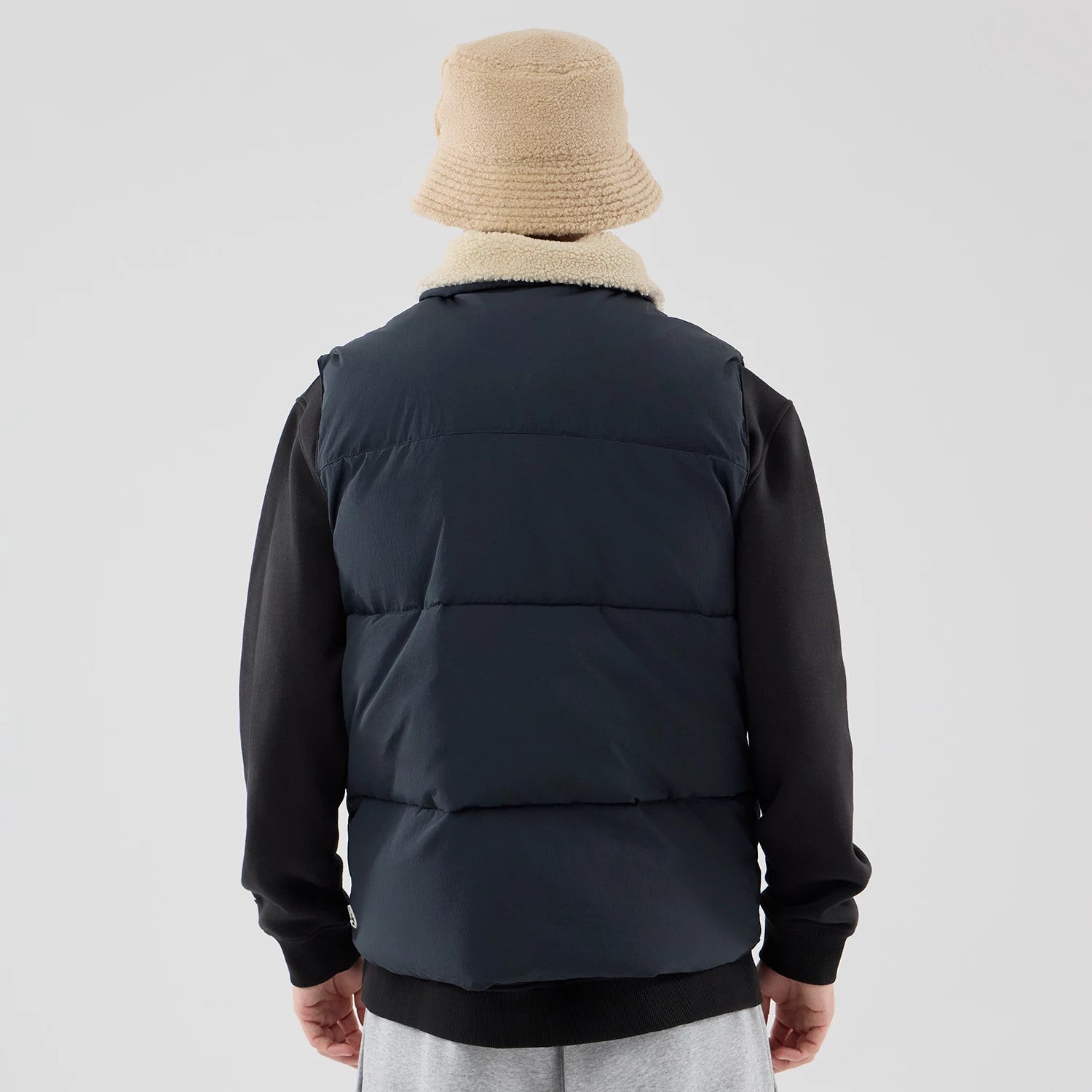 The Male model is wearing New Era Organic Boa Neck Navy Gilet 2