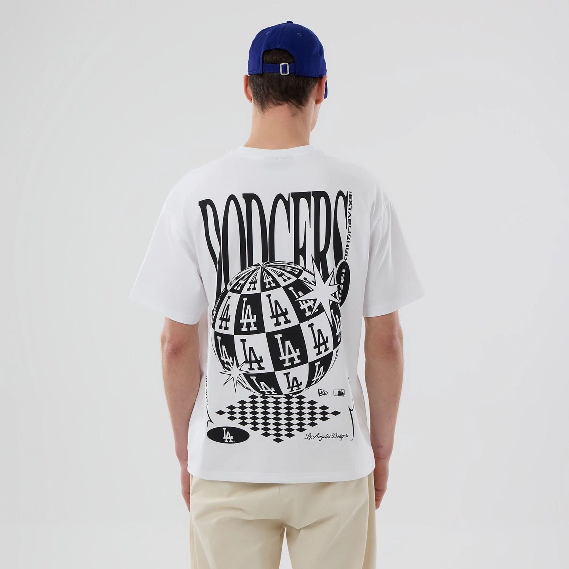 The model is wearing this MLB Chequered LA Dodgers T-Shirt in white. 2