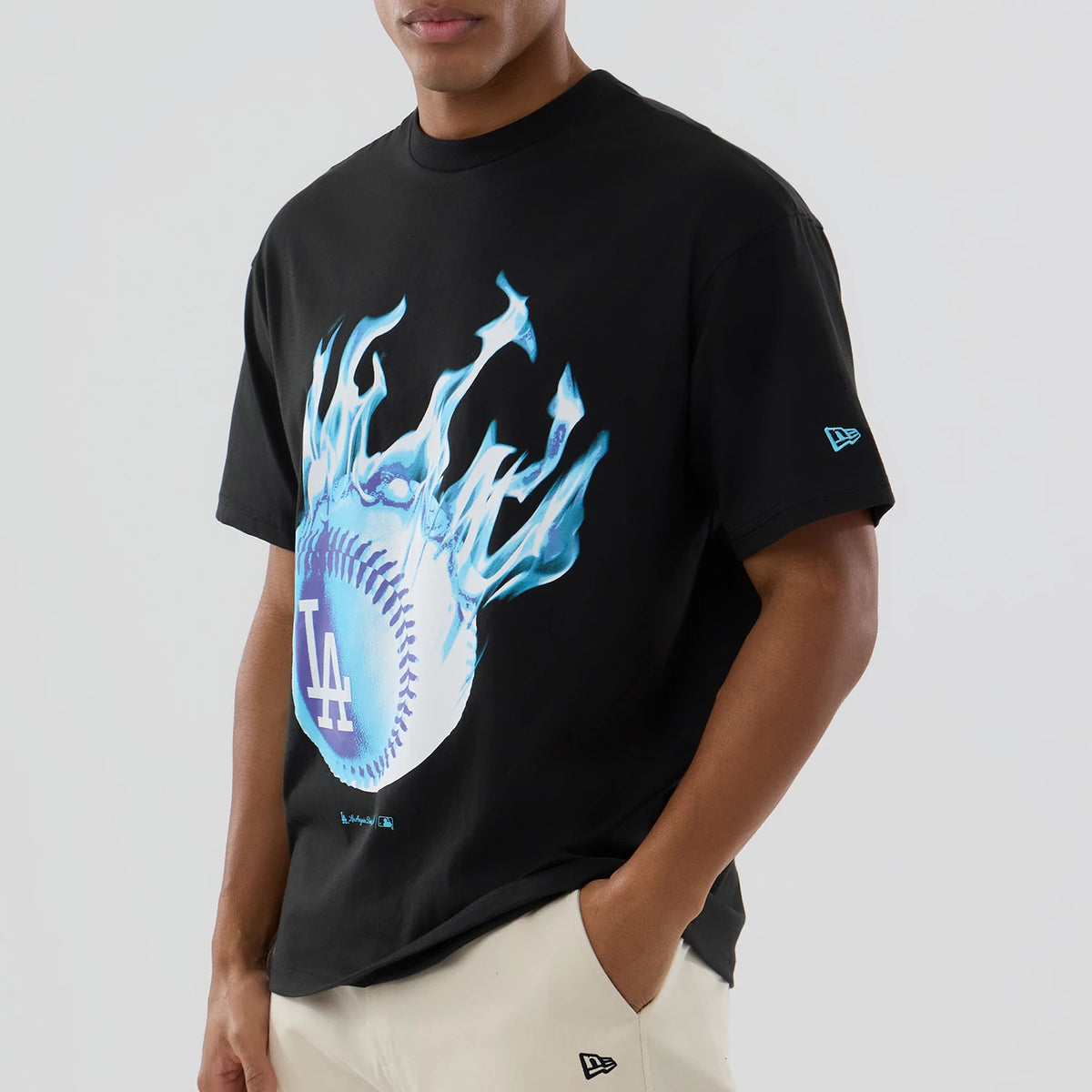 LA Dodgers MLB On Fire Black Oversized T-Shirt, on-model view showing a flaming blue baseball graphic with the white LA logo on the chest and a raised New Era logo on the left sleeve.