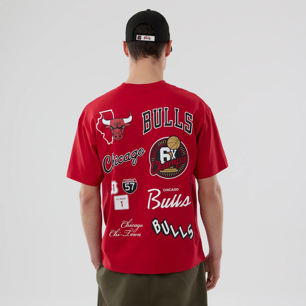 Chicago Bulls NBA logo Red T-Shirt, rear view showing various printed graphics including the Bulls logo, "Bulls" text across the upper back, and "6x Champs" emblem alongside Illinois icons on the red fabric.