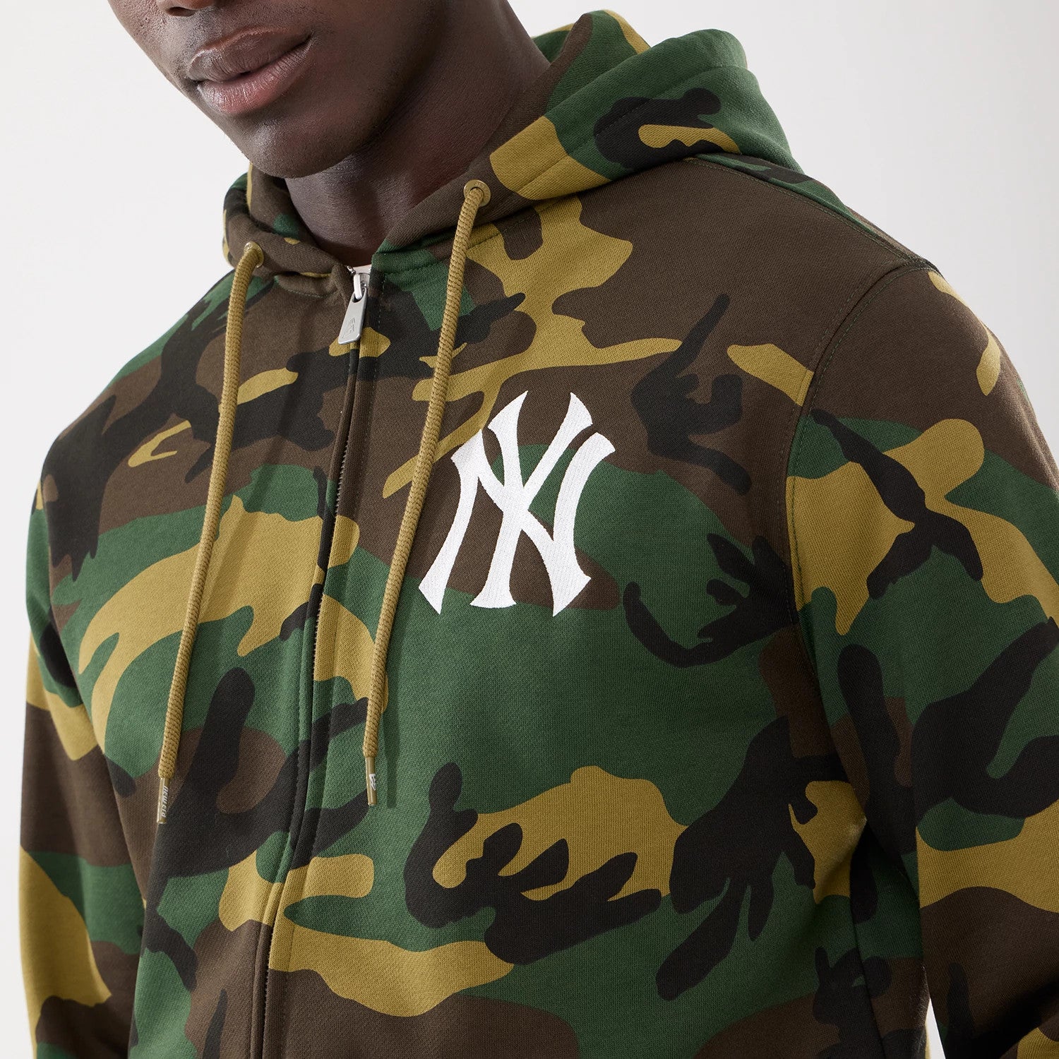 The model is wearing this MLB Camo New York Yankees 2 Way Full Zip Hoodie in Woodland Camo. 3