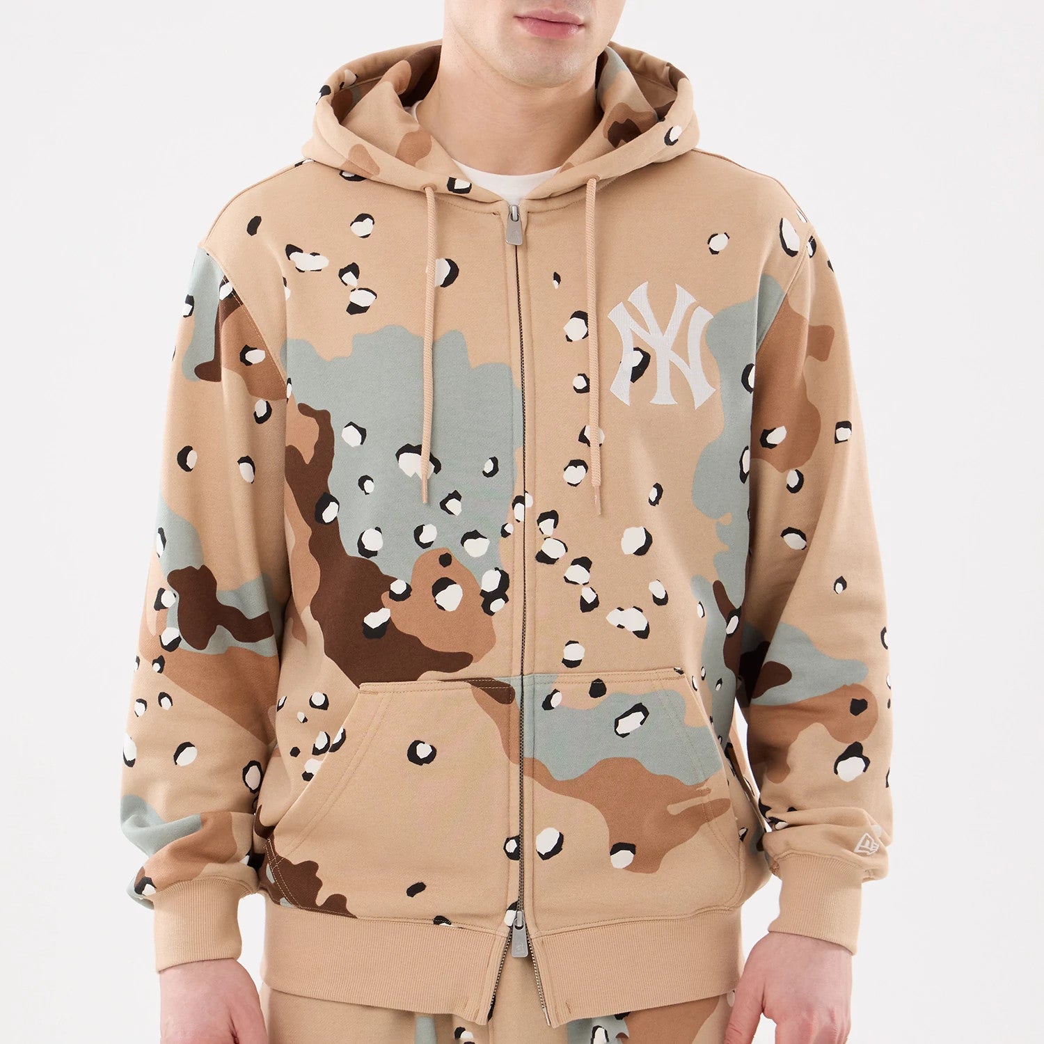 The model is wearing this MLB Camo New York Yankees 2 Way Full Zip Hoodie in Desert Camo. 3