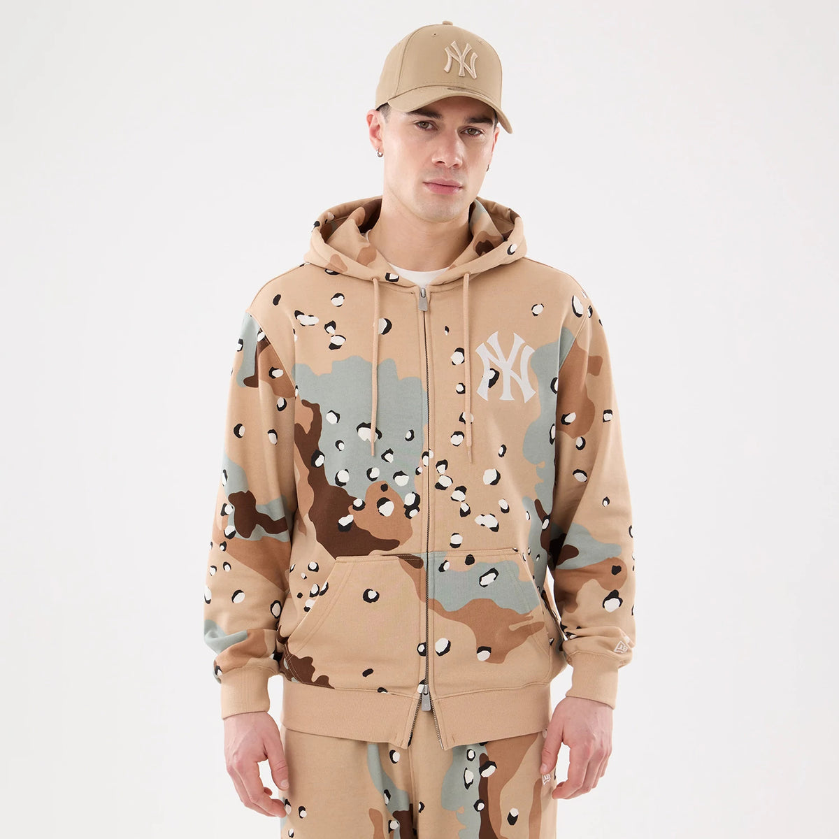 New York Yankees MLB Desert Camo 2 Way Full Zip Hoodie, front view showing the beige, brown, and green camo pattern with a white raised New York Yankees logo on the left chest and a full zip closure down the centre.
