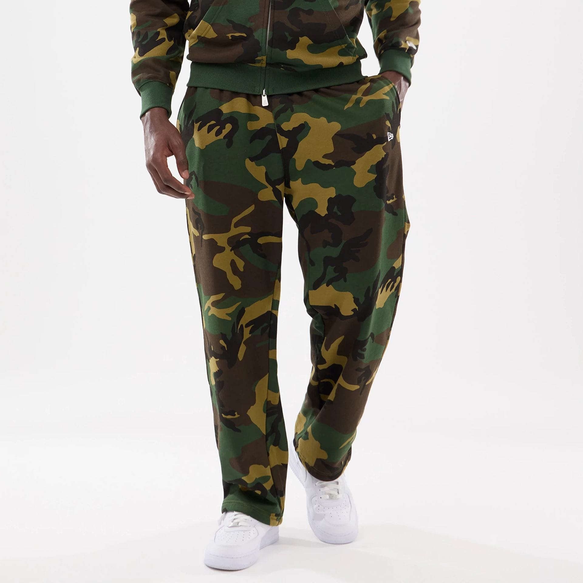 The model is wearing this New Era Woodland Camo Joggers in Woodland Camo. 1