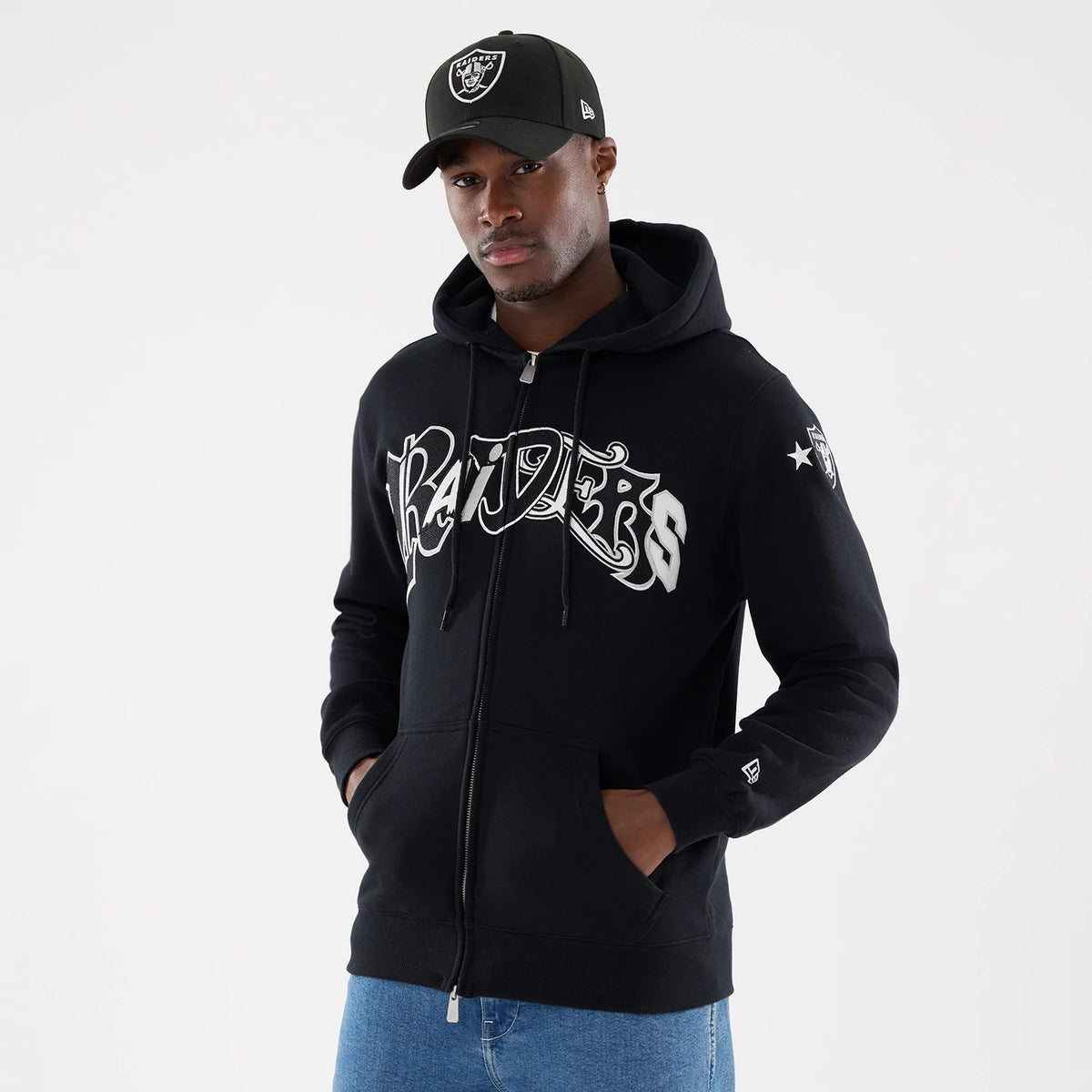 Las Vegas Raiders NFL Word Art Black 2 Way Full Zip Hoodie, on-model view showing the black hoodie with bold word art design across the chest, Raiders shield on the cap and sleeve, and a raised New Era logo on the left cuff.