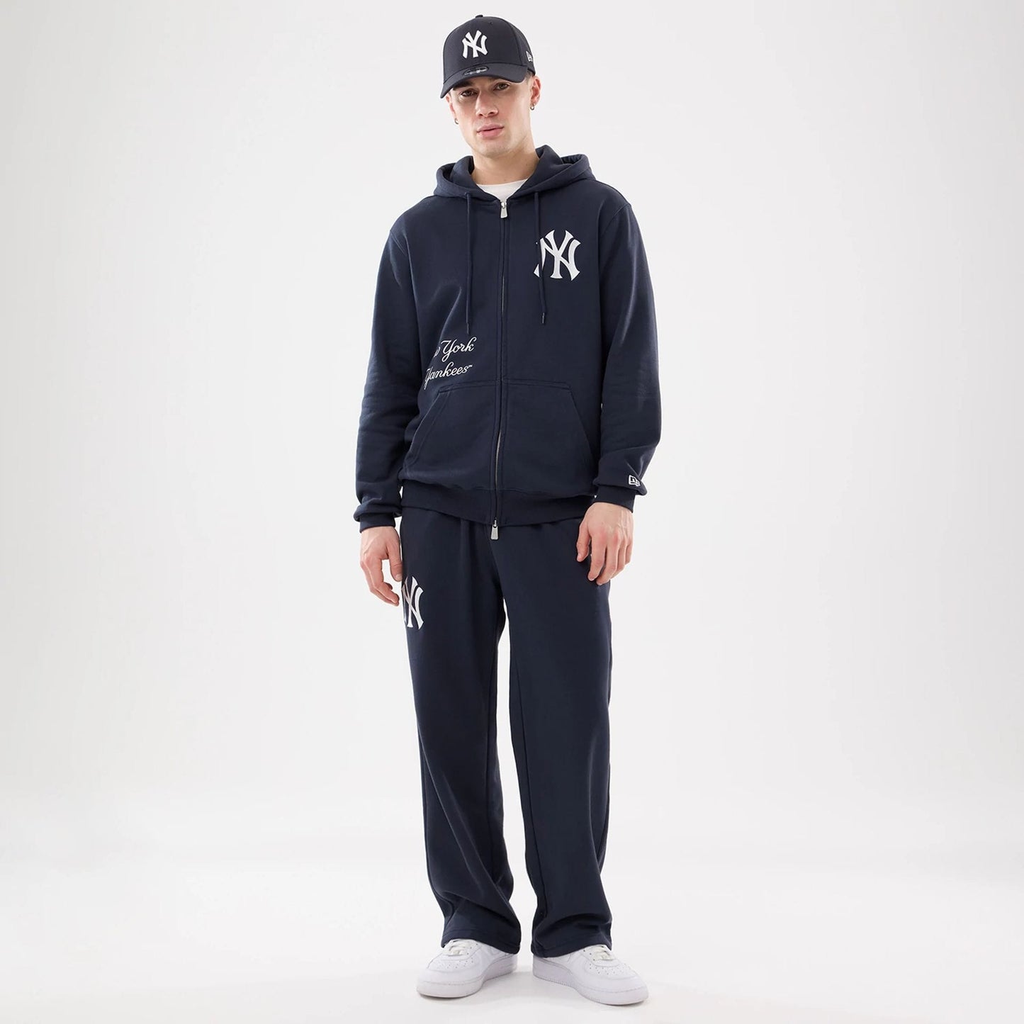 The model is wearing this MLB Comfort New York Yankees 2 Way Full Zip Hoodie in navy. 8