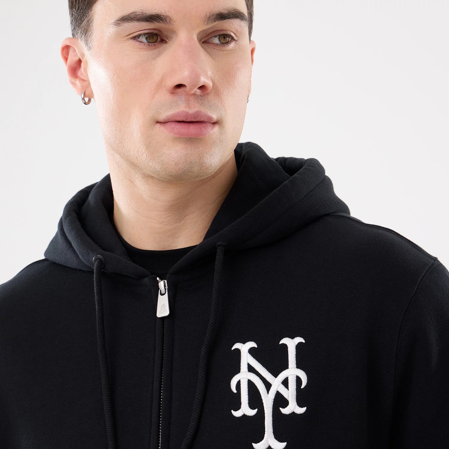 The model is wearing this MLB Comfort New York Mets 2 Way Full Zip Hoodie in black. 3