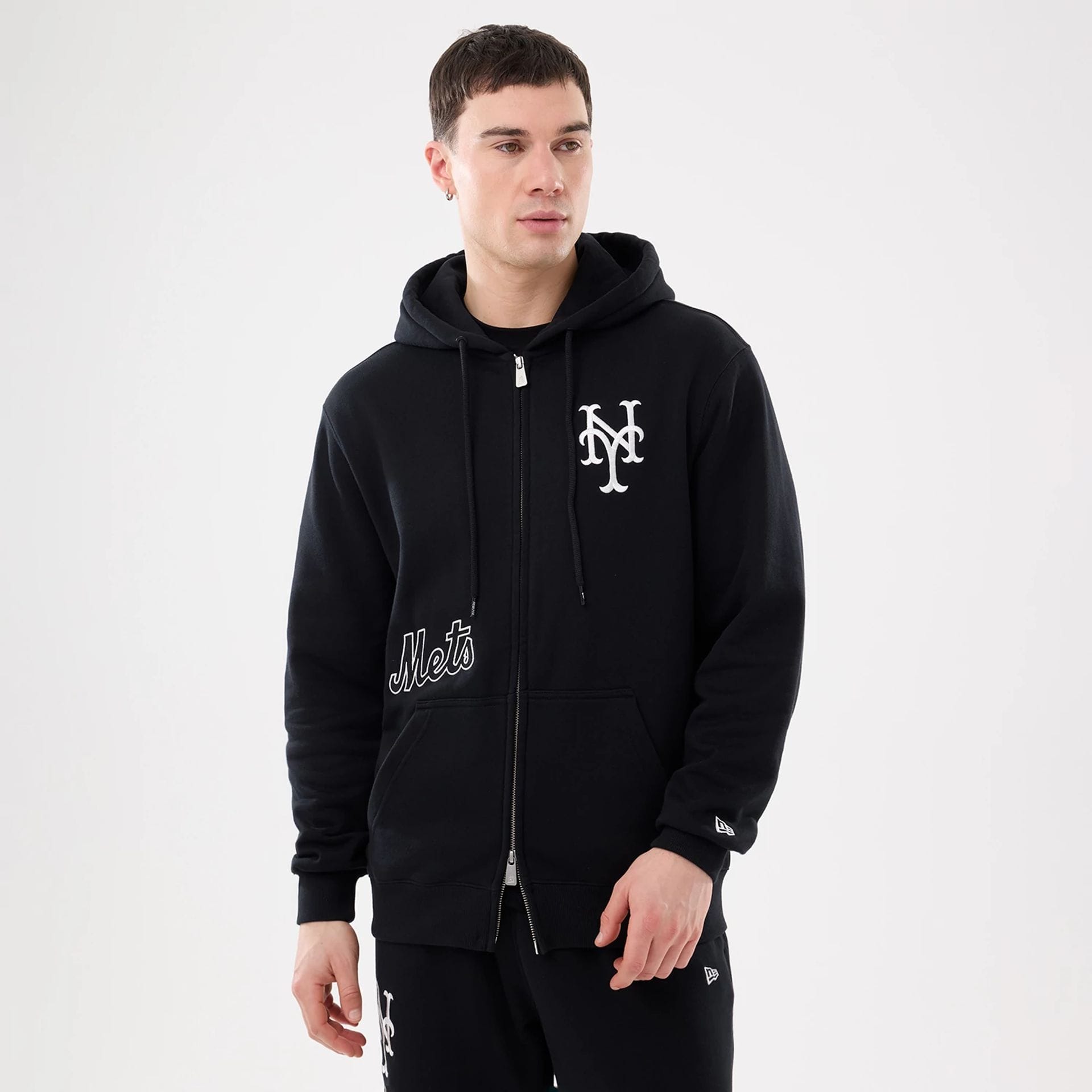 The model is wearing this MLB Comfort New York Mets 2 Way Full Zip Hoodie in black. 1